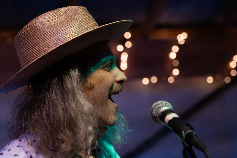 Man with hat singing